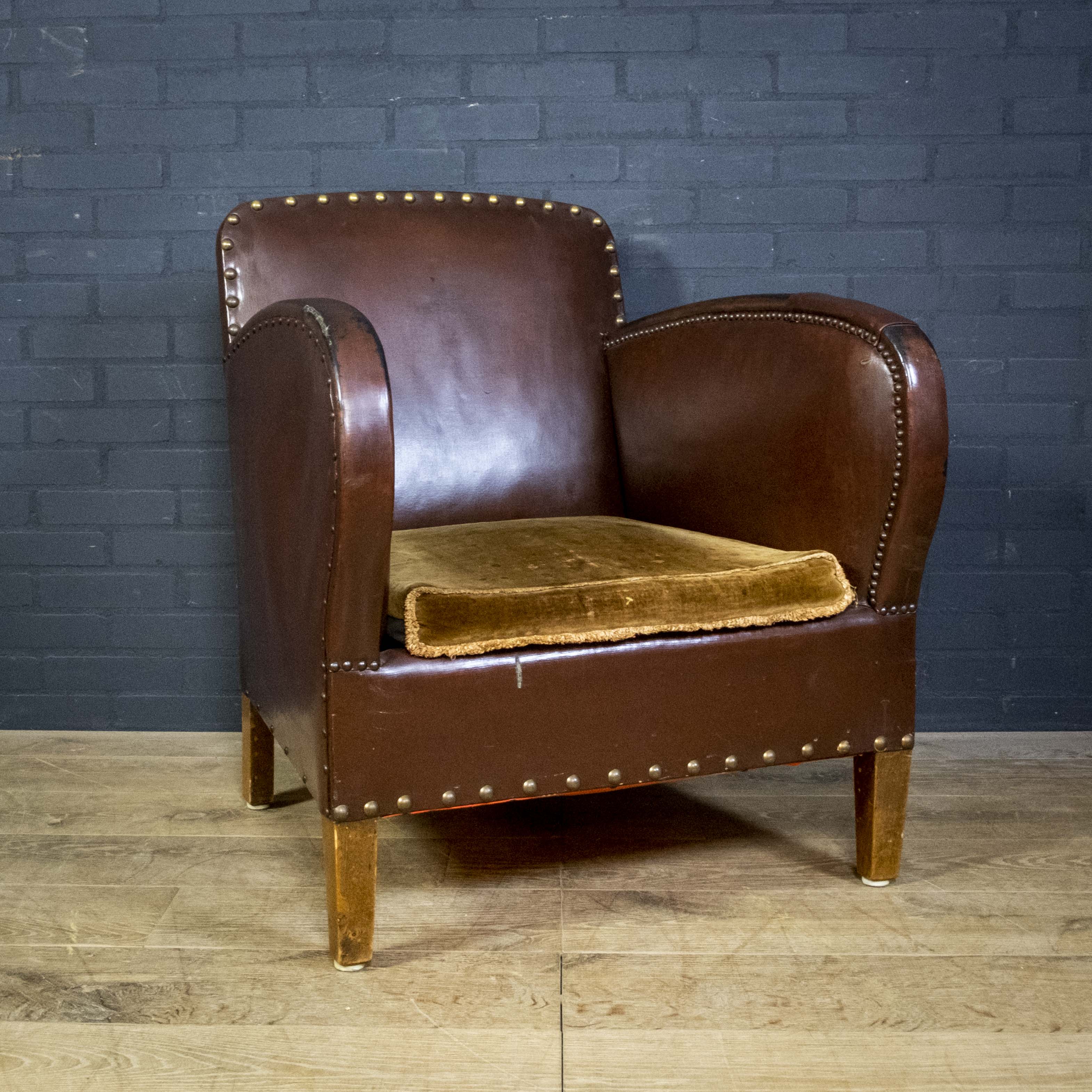 Antique club armchair of leather cloth