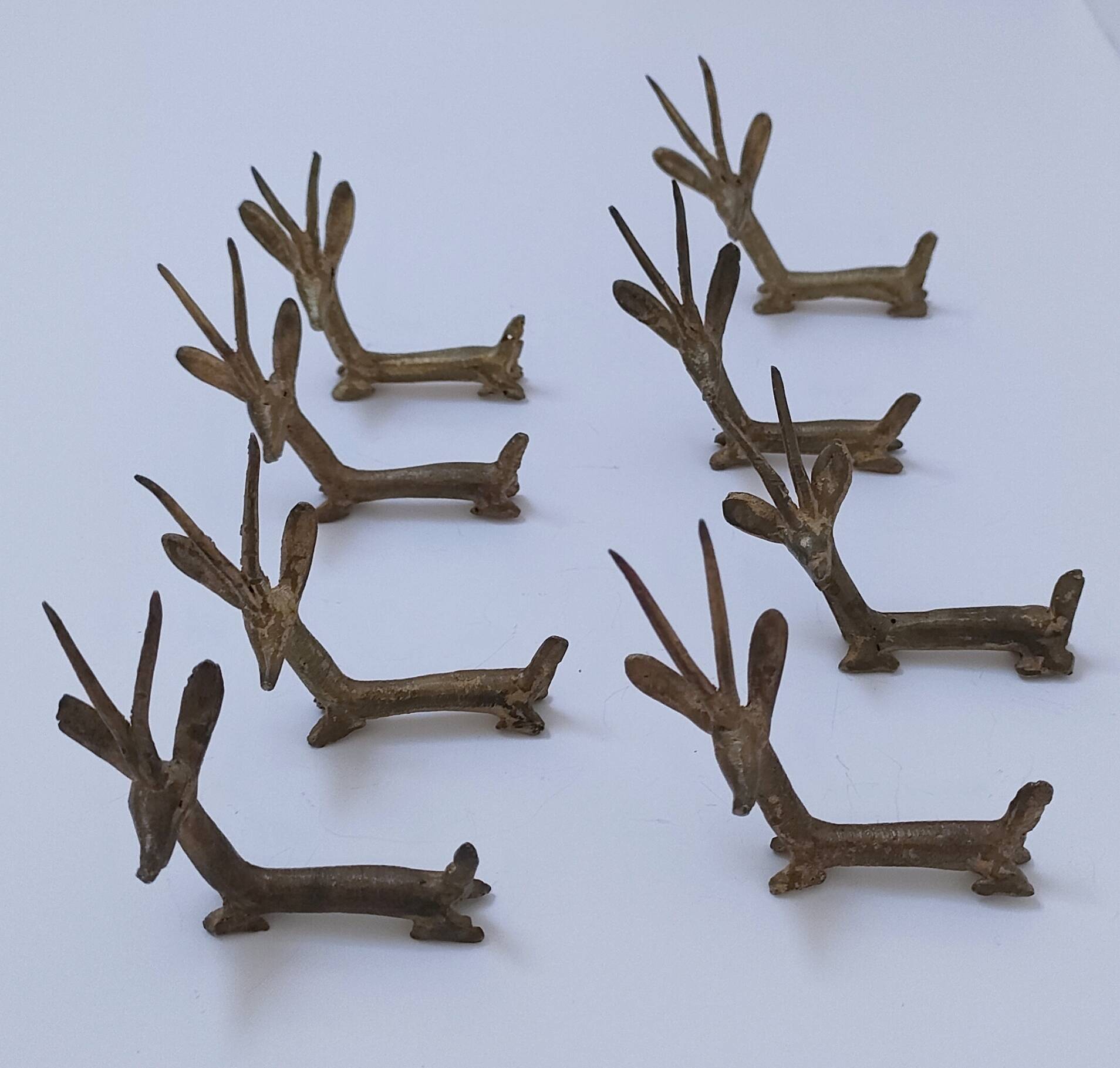 eight vintage brass Gazelle knife rests