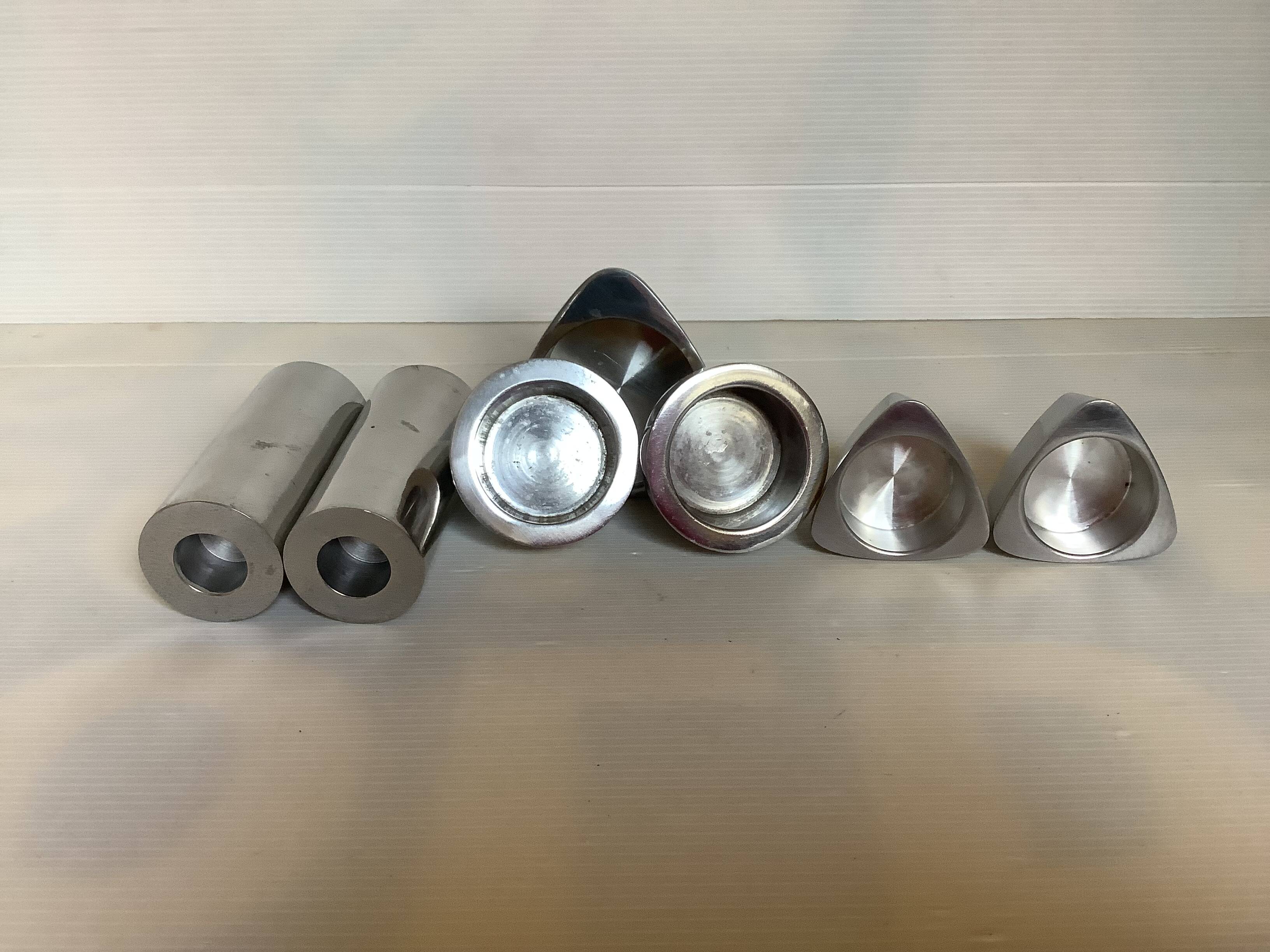 Seven different metal candle holders