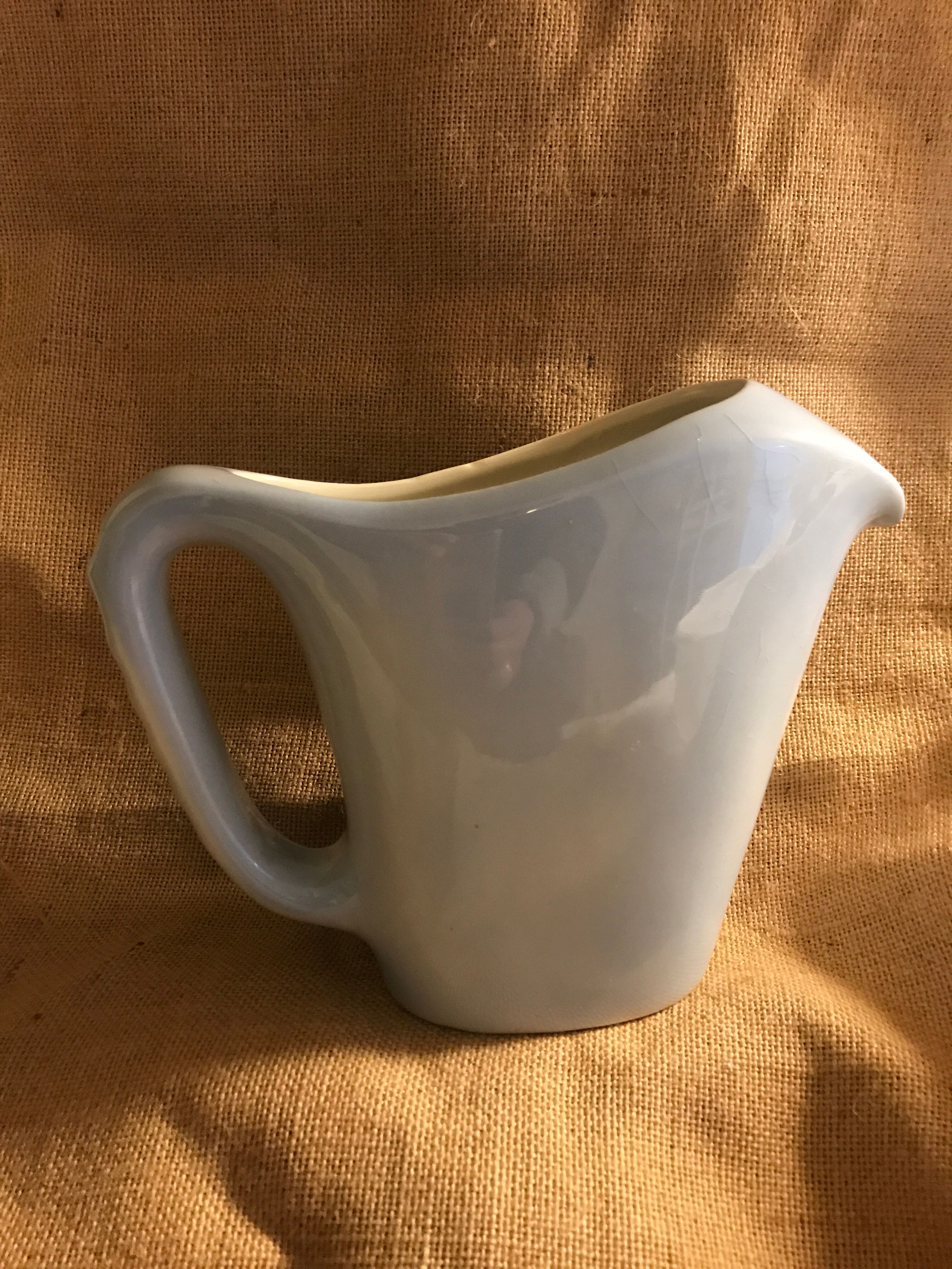 Light blue pitcher in vintage earthenware