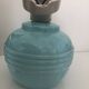 Wall light in ceramic with a light blue glass globe.