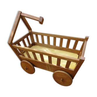 Wooden cradle in the shape of a carriage