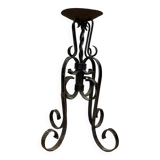 Wrought iron candlestick on four-legged base circa 1900-1930