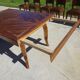 Antique solid walnut table with marquetry and extensions.