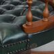 Dark green leather Chesterfield office chair on wheels.