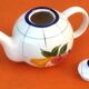 Coffee / teapot ball shape earthenware with fruit decoration