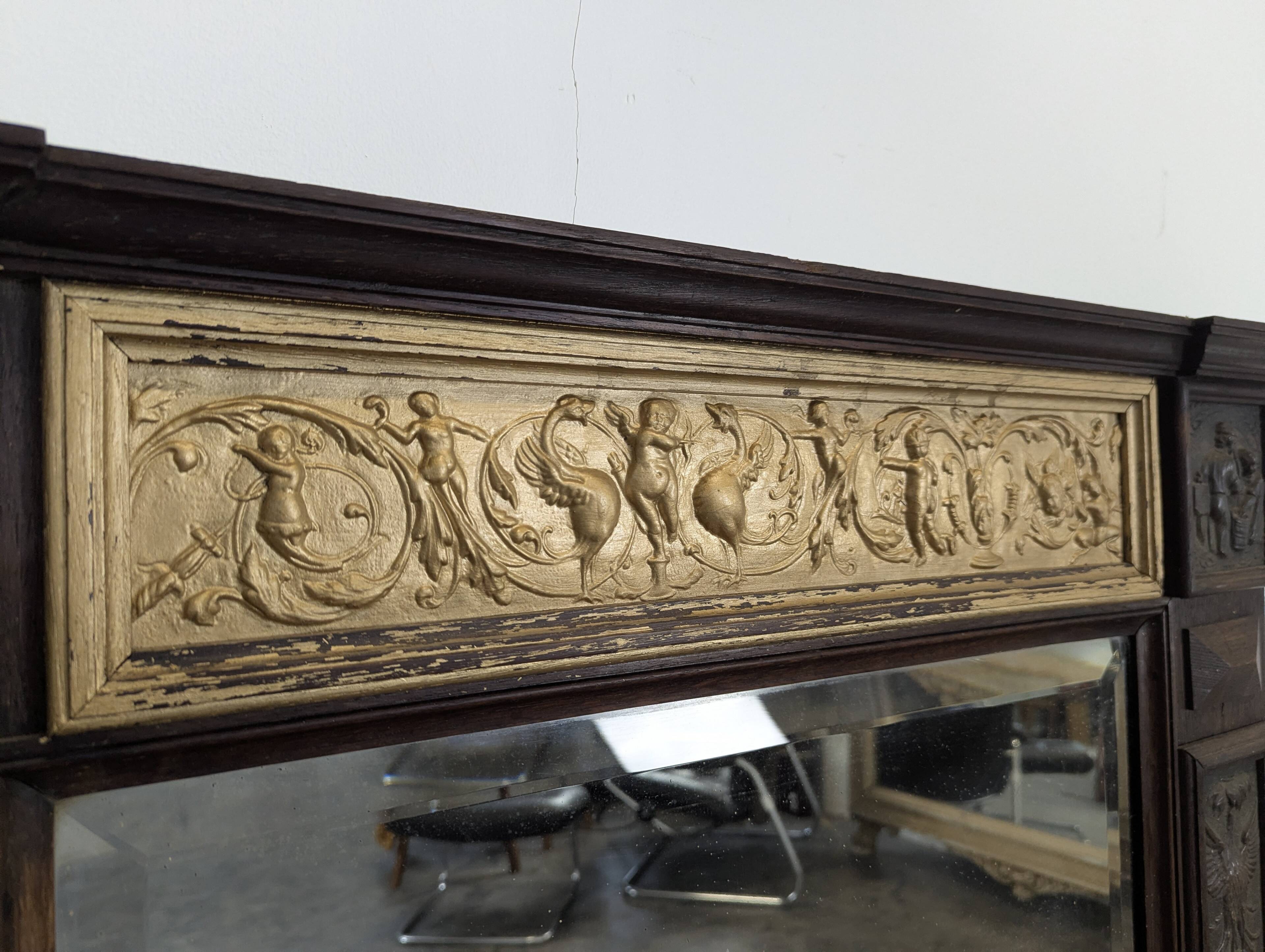 Renaissance-style mirror in wood and copper with a craftsmanship theme.