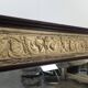 Renaissance-style mirror in wood and copper with a craftsmanship theme.