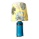 Blue ceramic lamp with claw feet and foliage lampshade.