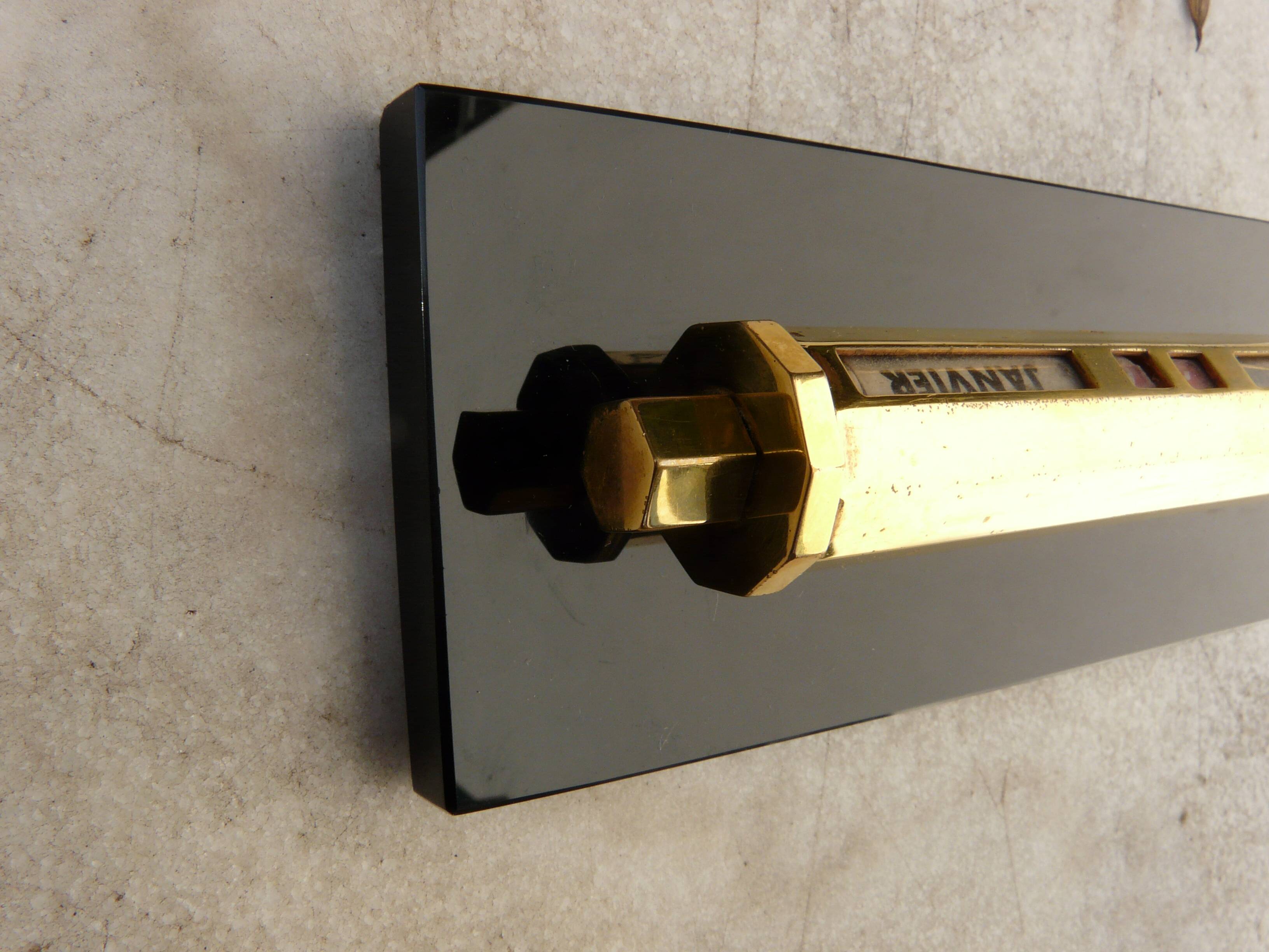 Tubular gold starry perpetual calendar, black base, 1950s