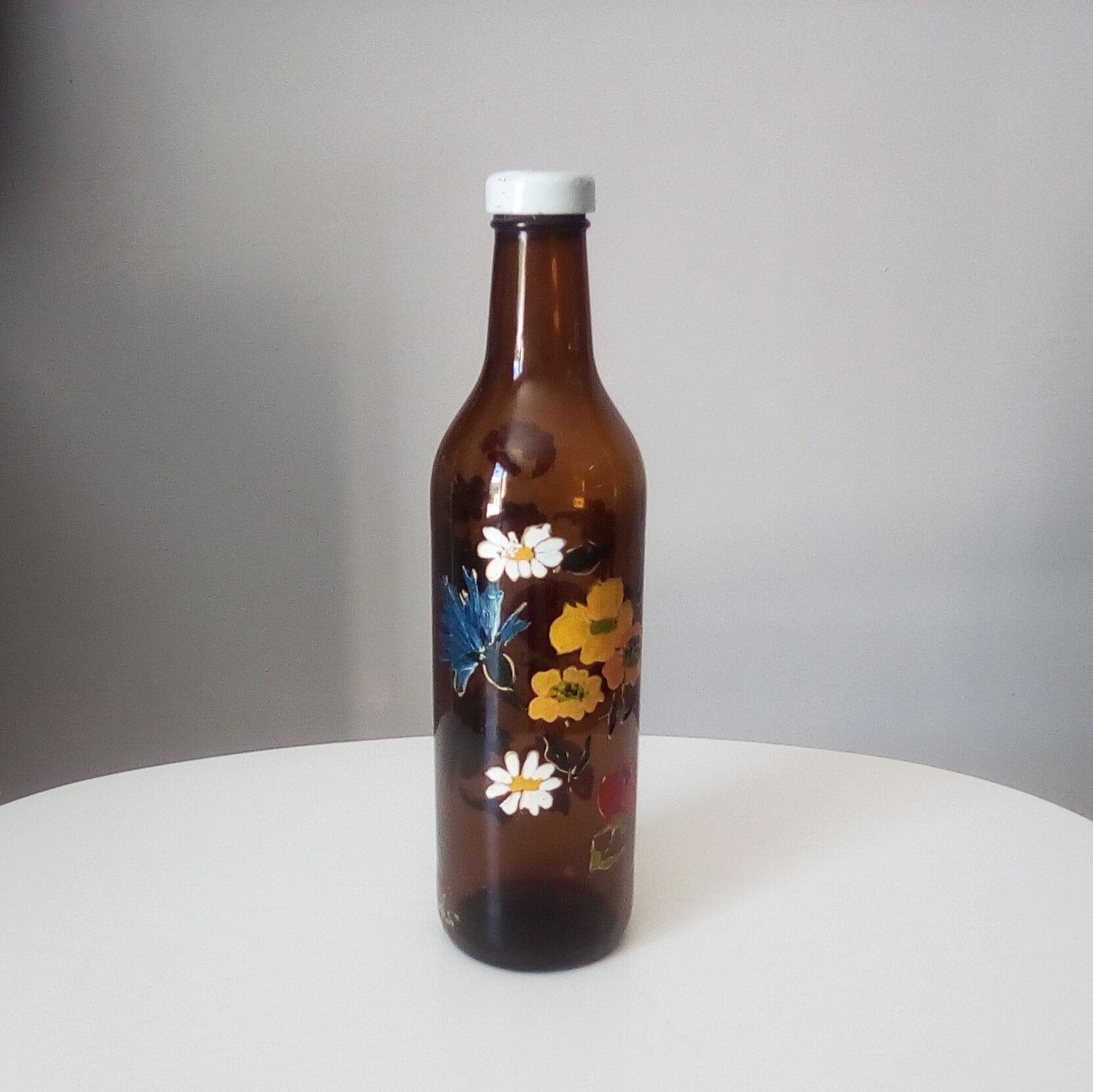 Vintage hand-painted amber glass bottle