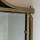 Neoclassical style mirror in brass and lacquered sheet metal.