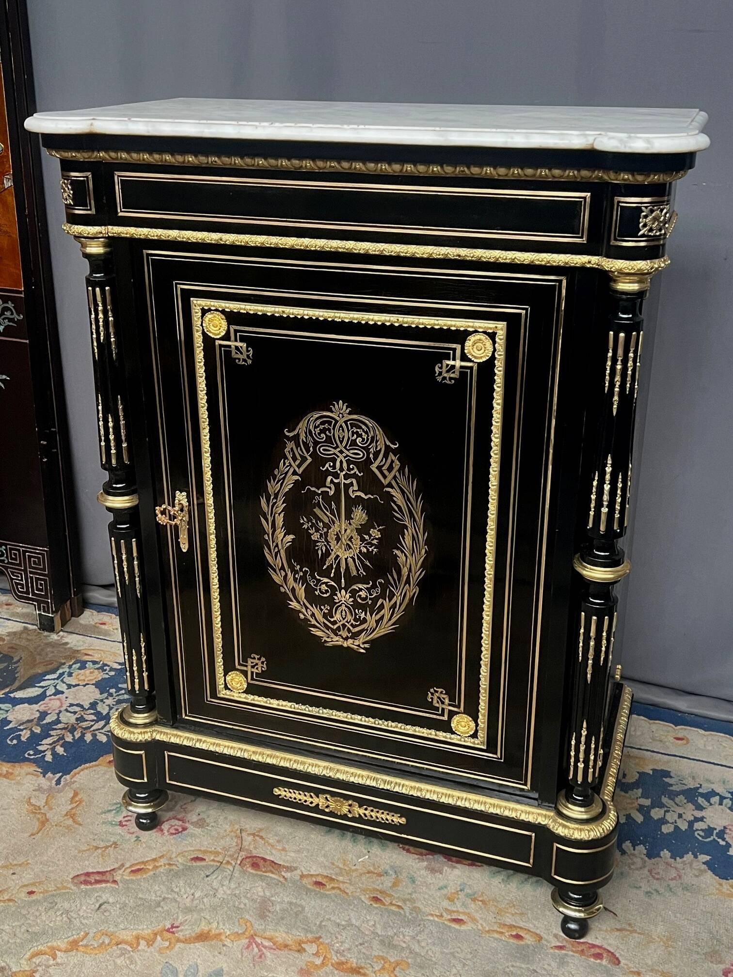 Napoleon III style commode, decorated with brass marquetry and gilded bronze mounts.