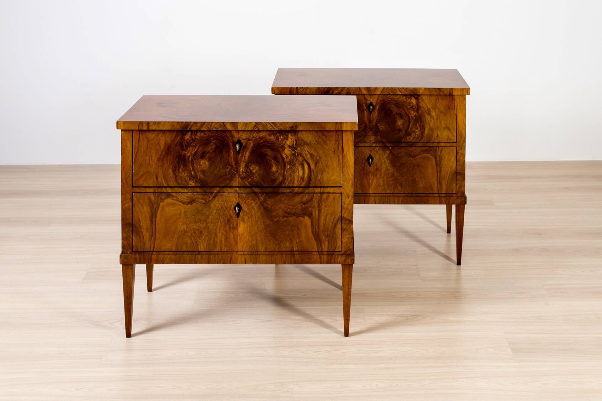 Elegant pair of Biedermeier style walnut commodes, Germany, French polish.