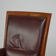 Very comfortable classic cowhide armchair with a high back in a mild Art Deco style