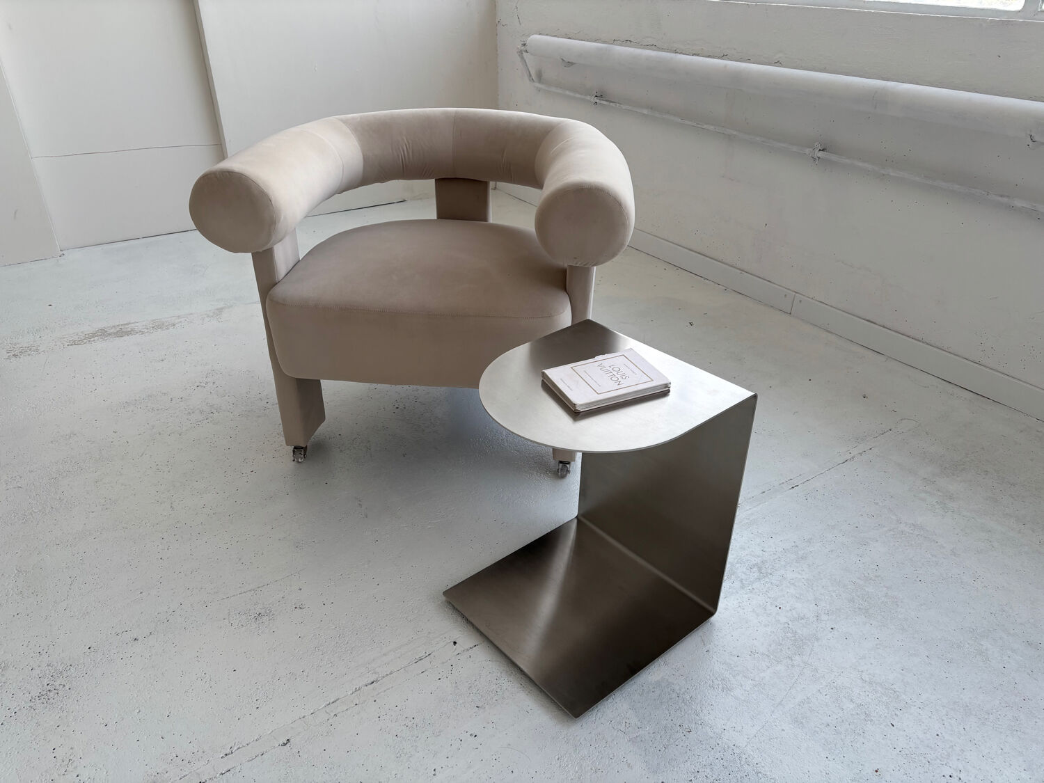 C-shaped brushed stainless steel side table