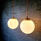 Pair of Art Deco pendant lights in brass and white opaline, 1920-30