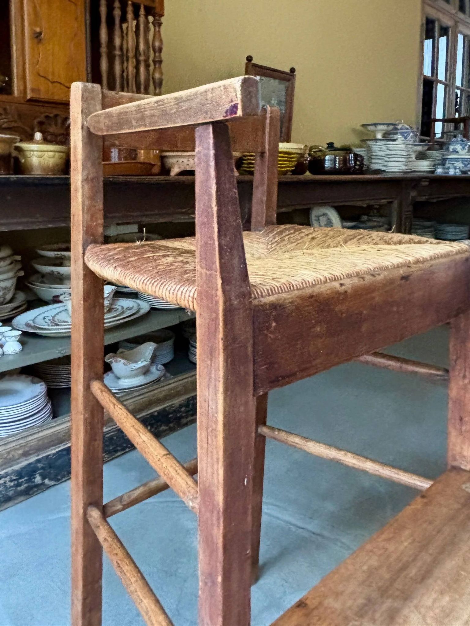 High chair made of wood and straw.