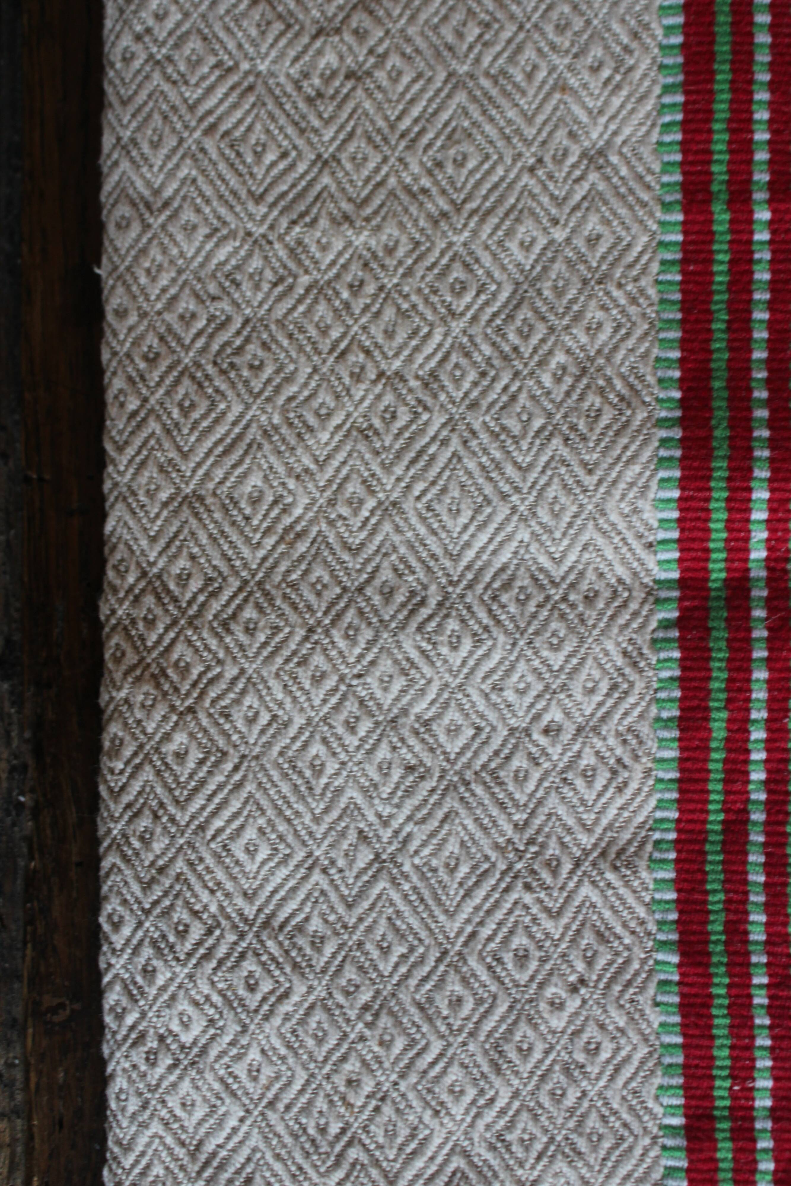 Old chevron towel with red and green stripes.