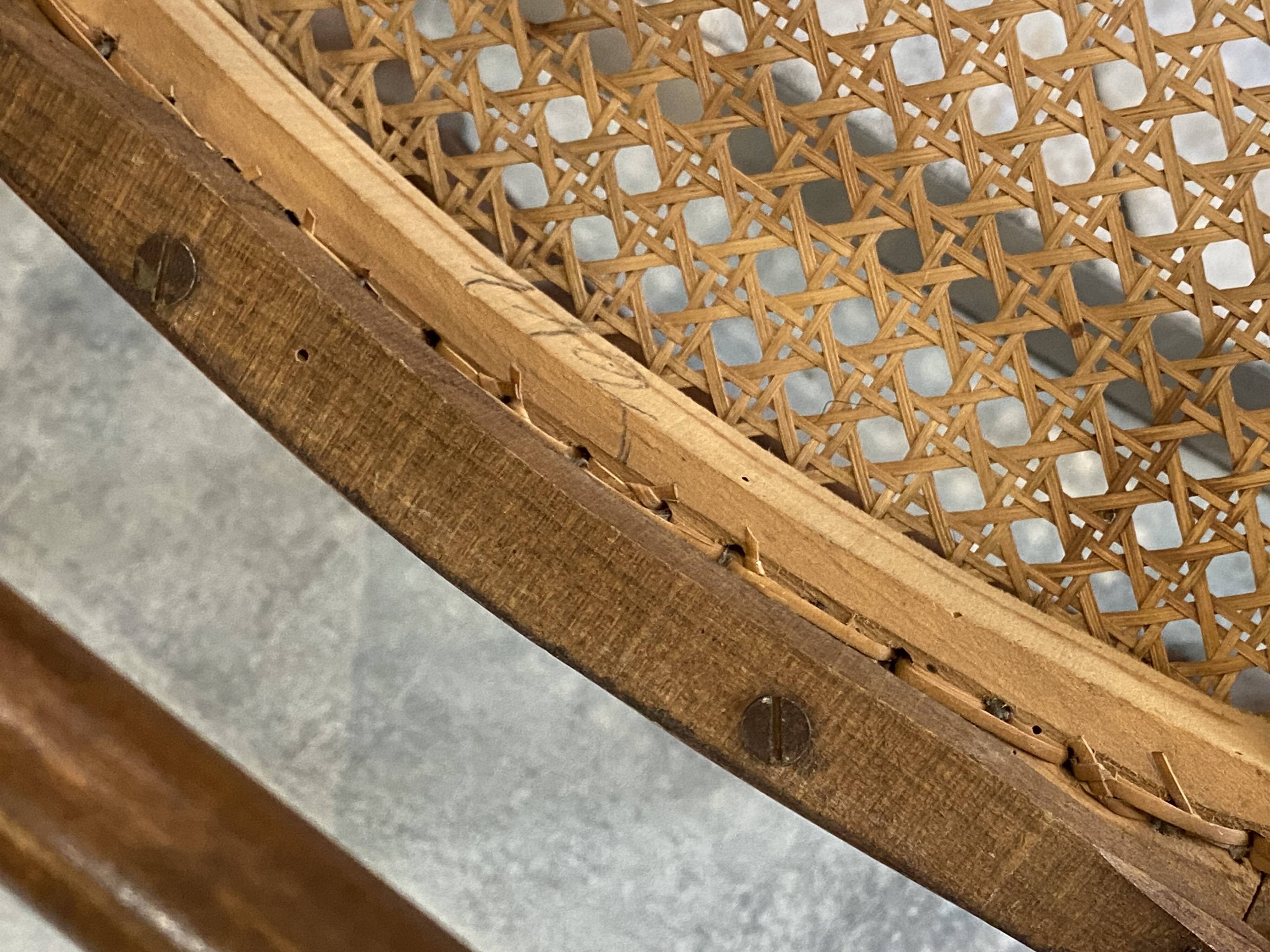 Pair of antique caned and wooden chairs from the 1900s.