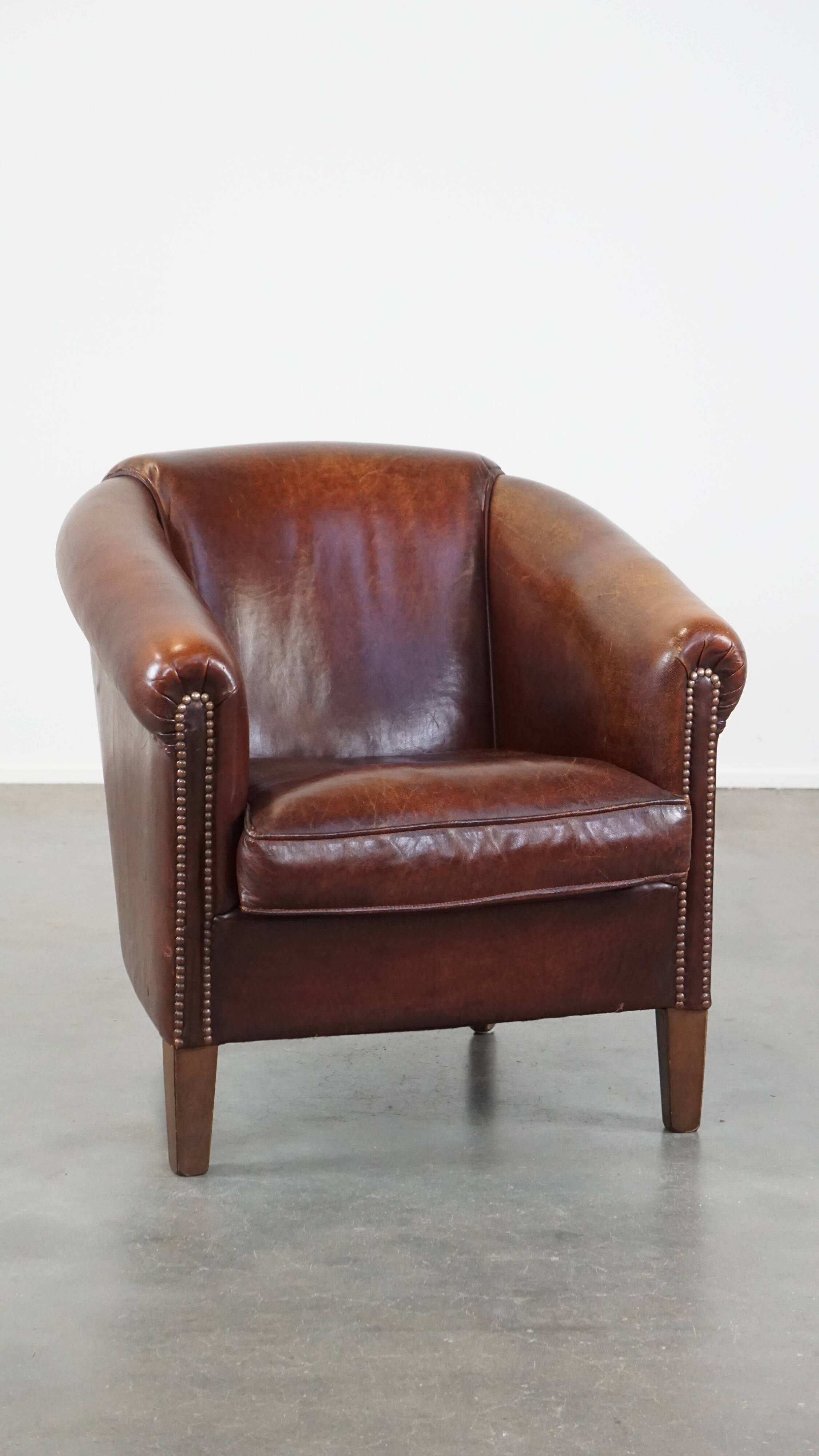 Sheepskin club armchair, correct finishing with decorative nails