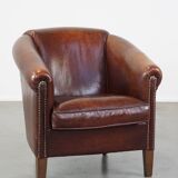 Sheepskin club armchair, correct finishing with decorative nails
