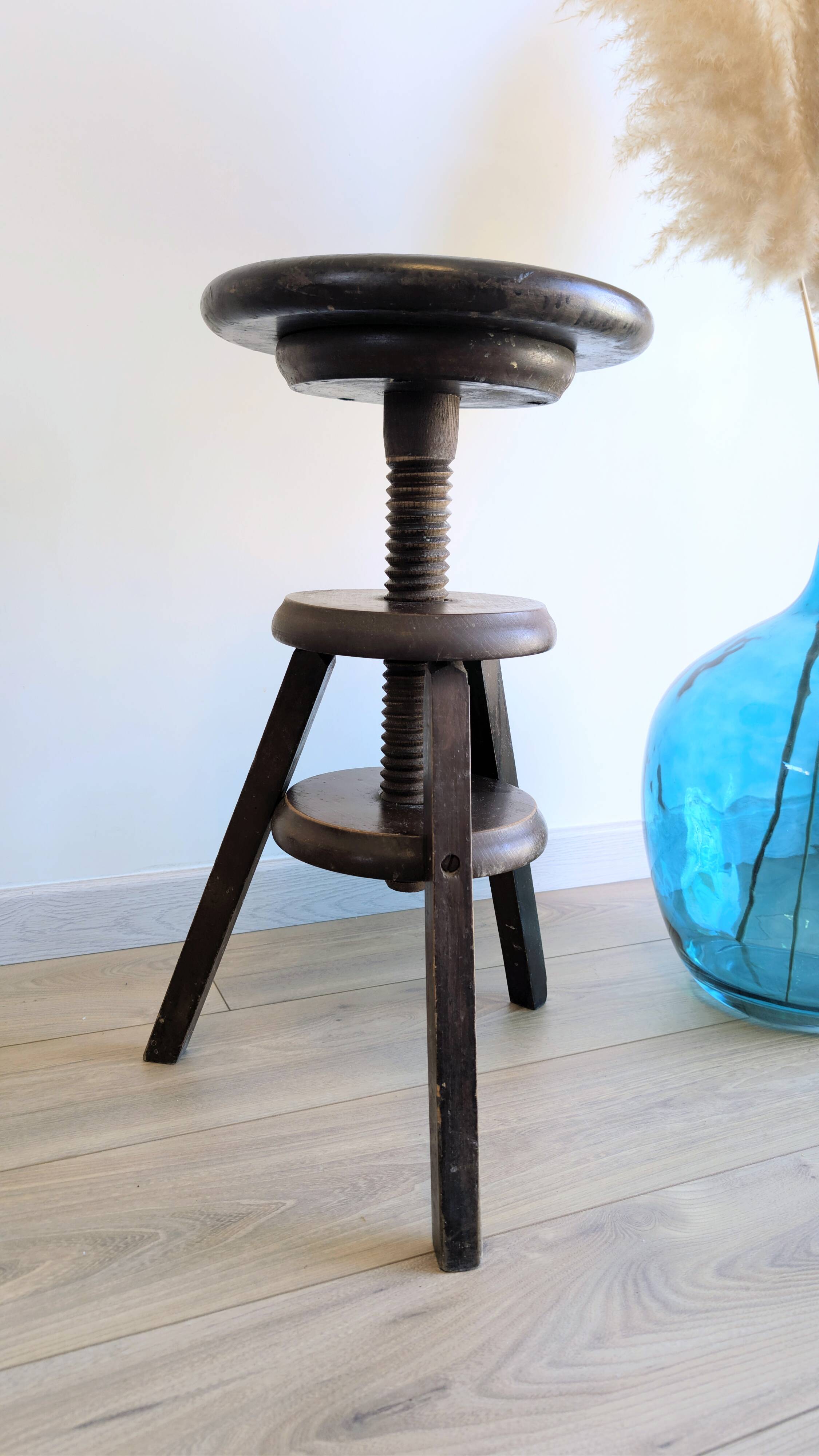 Antique wooden watchmaker's stool with screws, patinated wood.