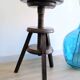 Antique wooden watchmaker's stool with screws, patinated wood.