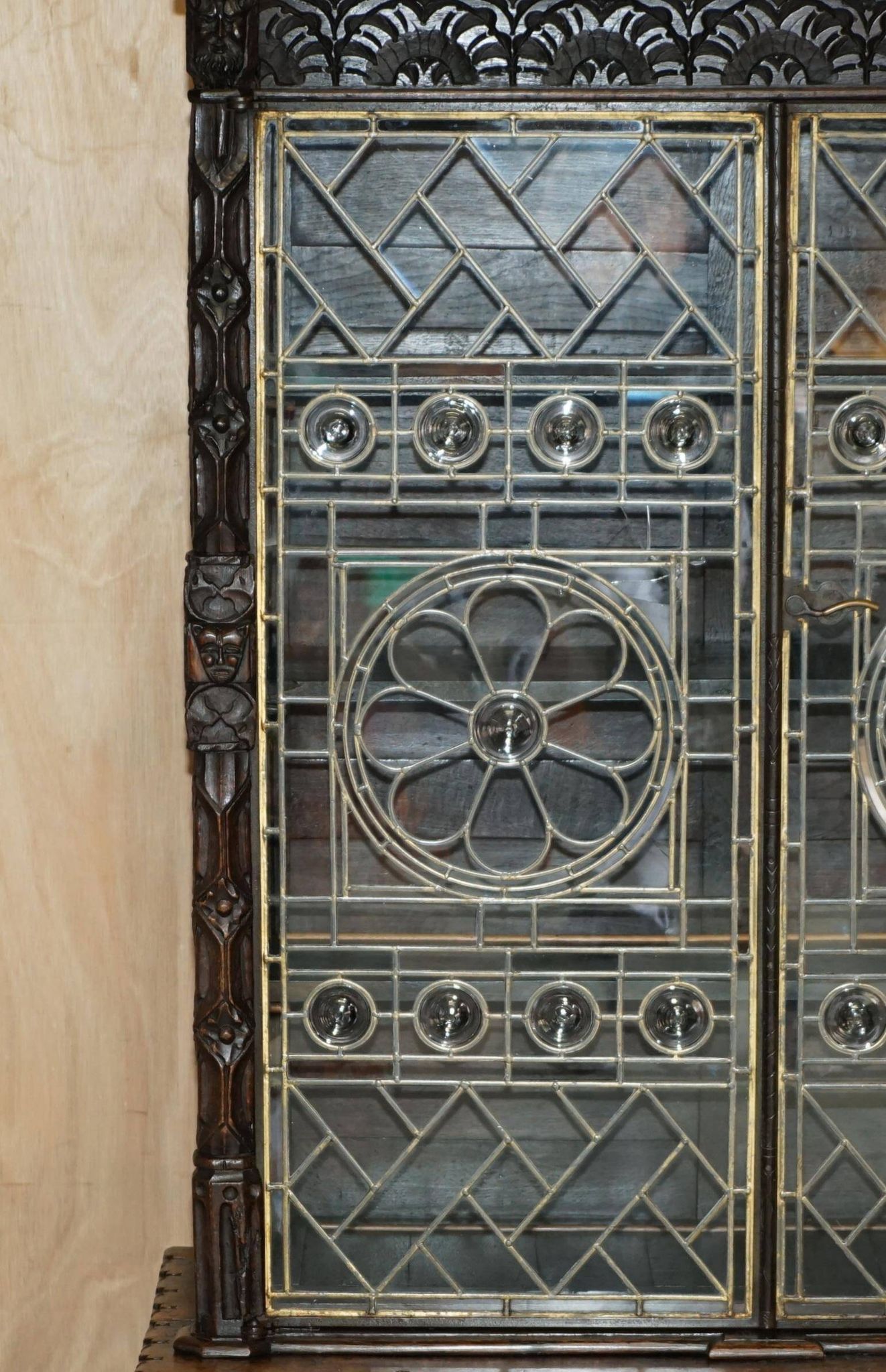 Jacobean hardwood library with carved panels and glass doors.