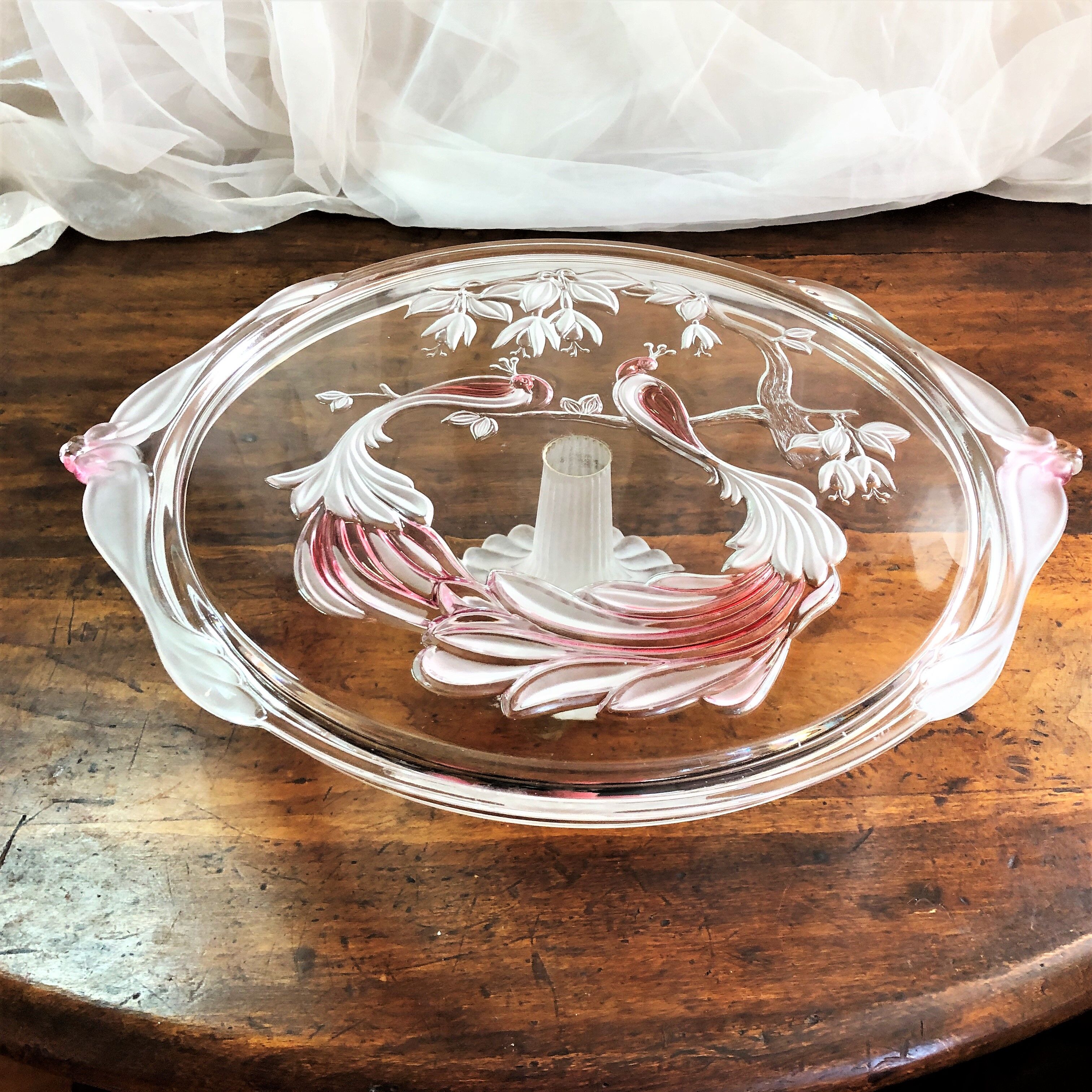 Large pie dish cakes on pedestal decorated with peacocks