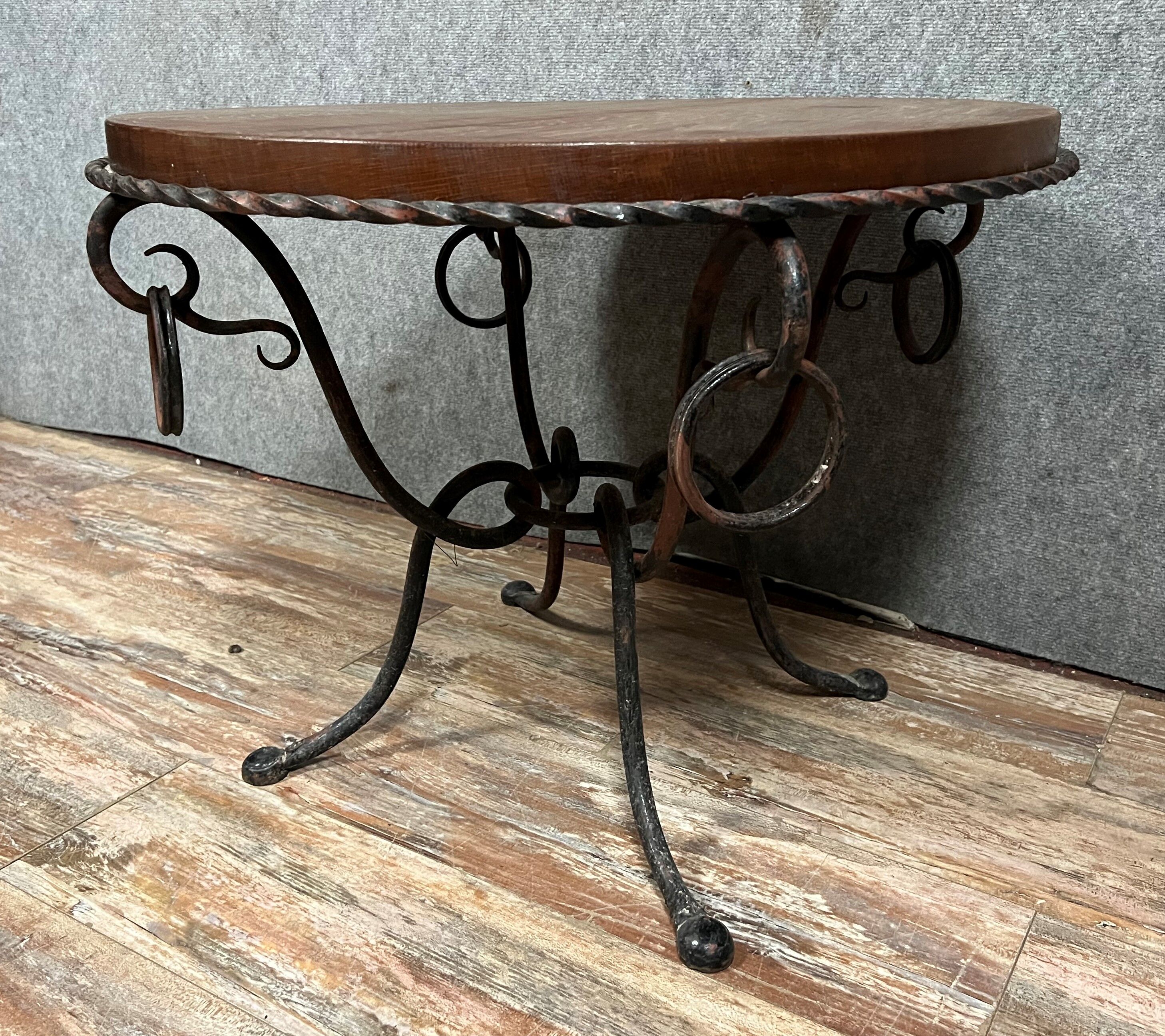 Hammered iron coffee table with circular wooden top