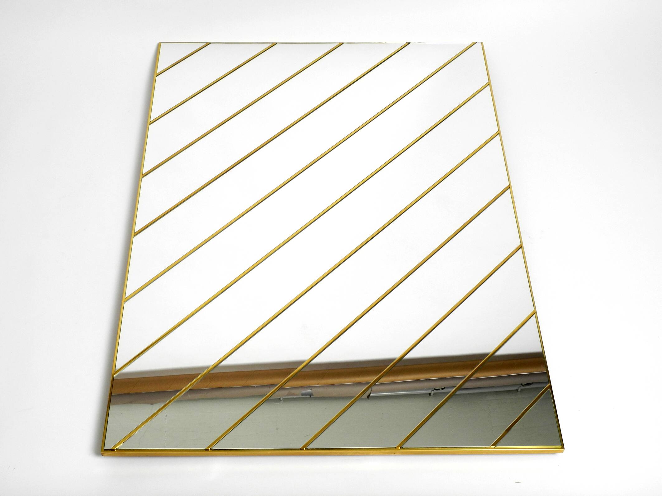 Large, exceptional 1970s brass wall mirror with diagonal mirror strips