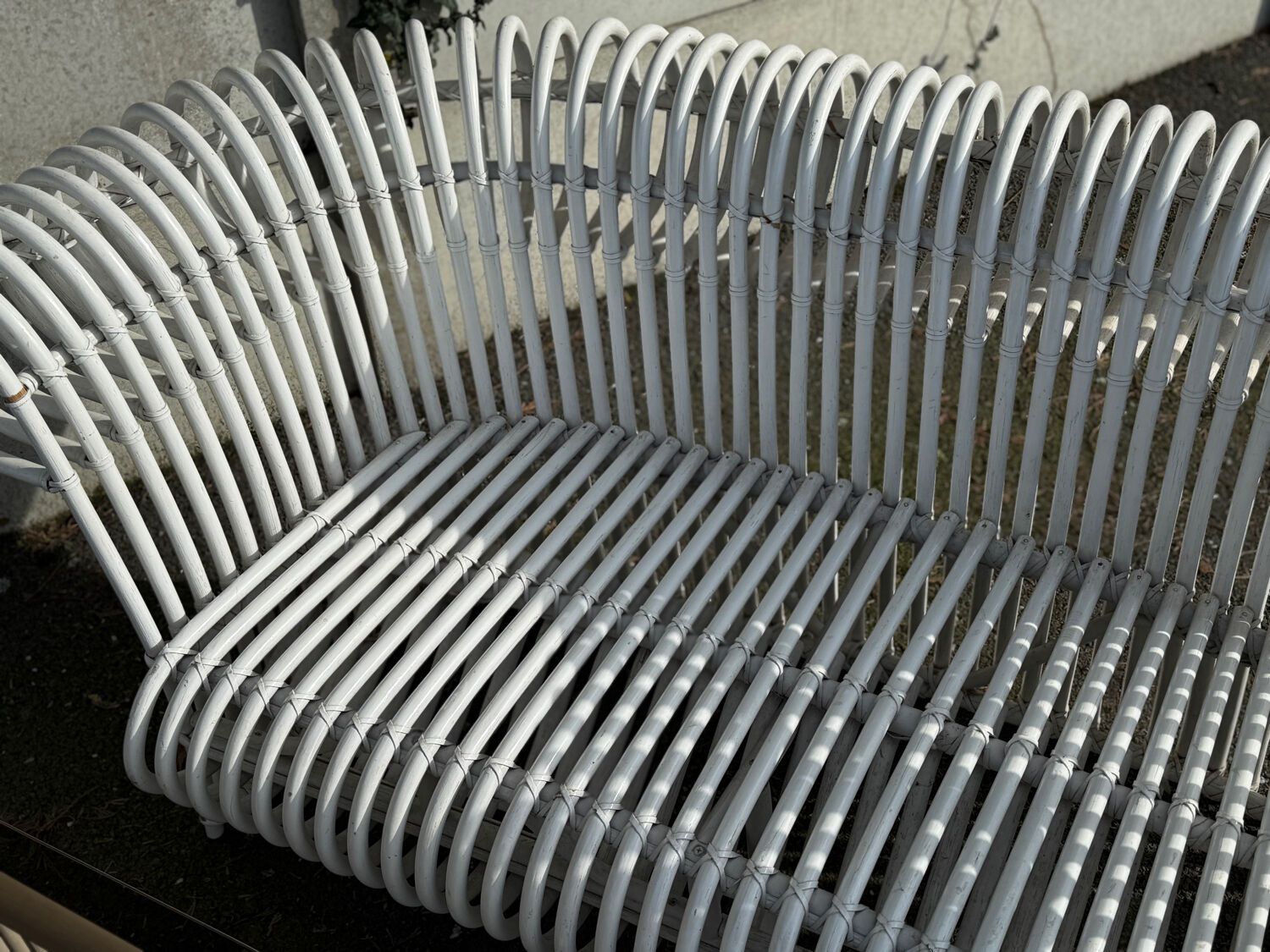 Rattan lounge with two two-seater sofas and a white coffee table.