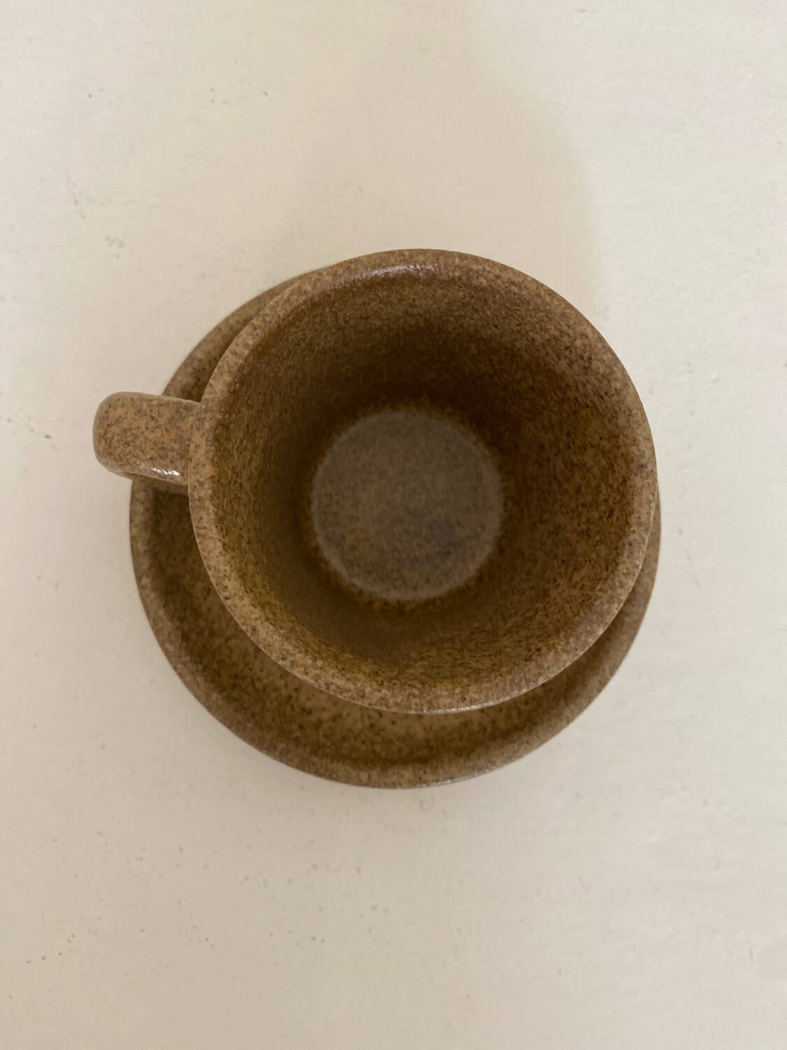 Set of stoneware coffee cups with saucers