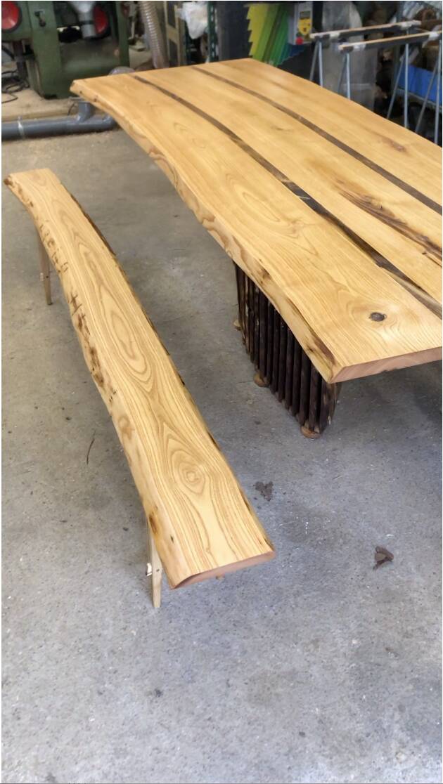 Chestnut and walnut solid table and benches with a central leg.
