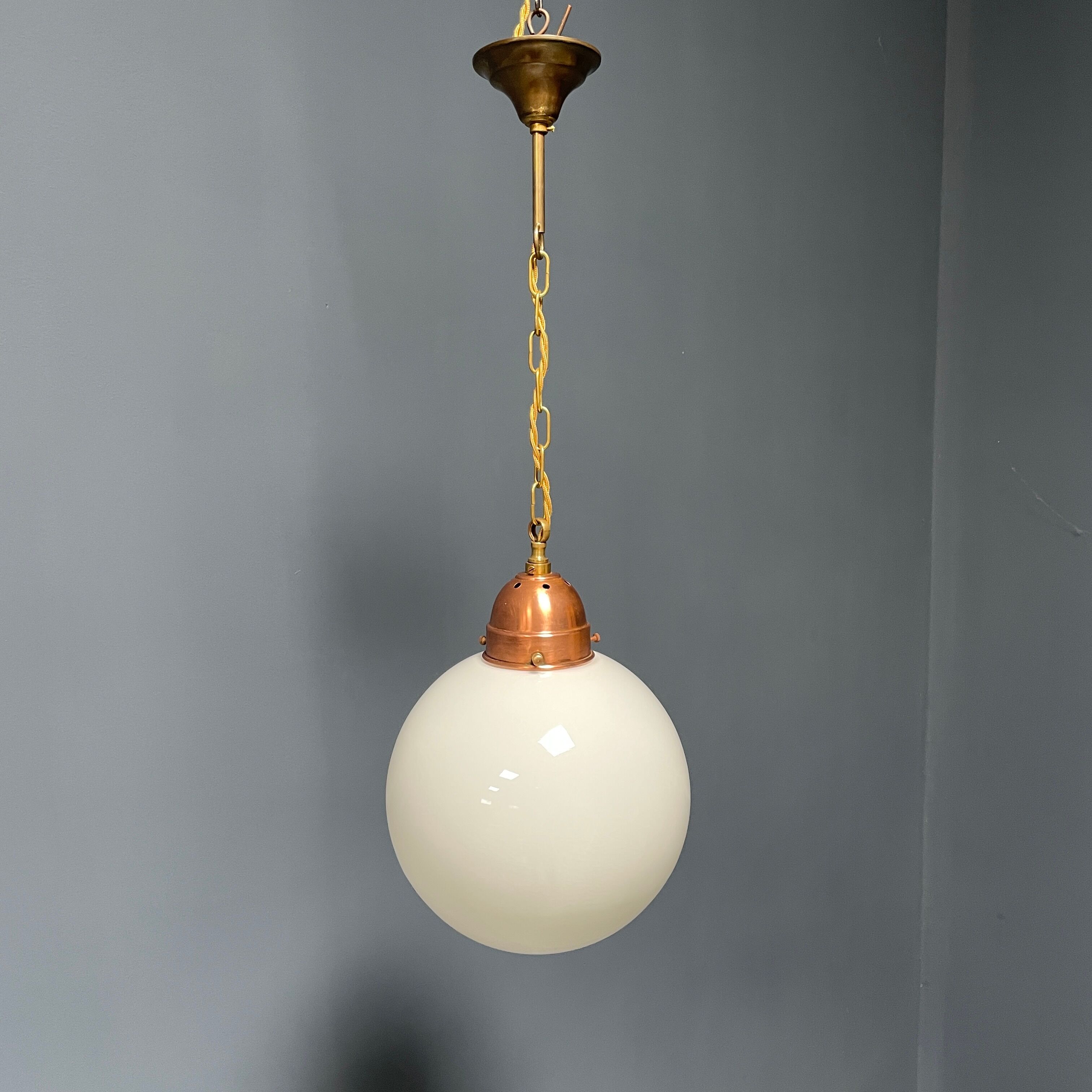 Opaline glass ball hanging lamp with copper fixture