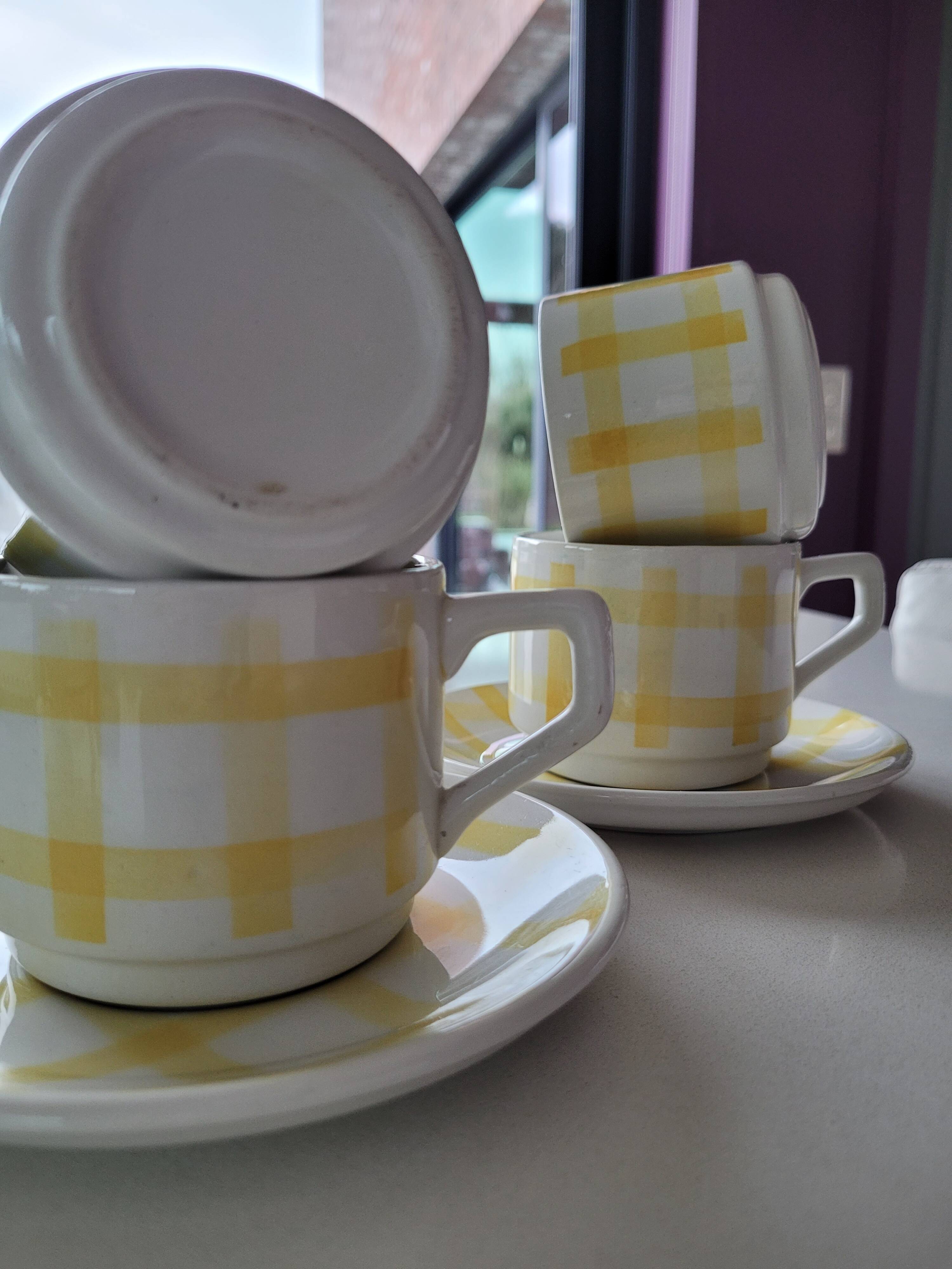 4 cups, 2 under cups yellow and white tea towel pattern