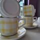 4 cups, 2 under cups yellow and white tea towel pattern
