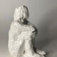 White ceramic seated sculpture