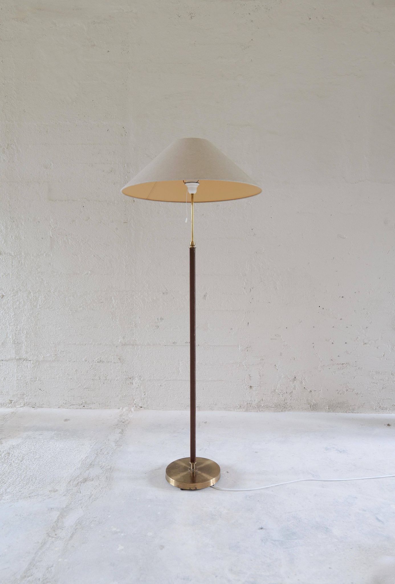 Mid-century brown leather and patinated brass floor lamp by Falkenbergs Belysning, Sweden, 1960s.