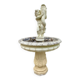 Beautiful old stone garden fountain with child statue