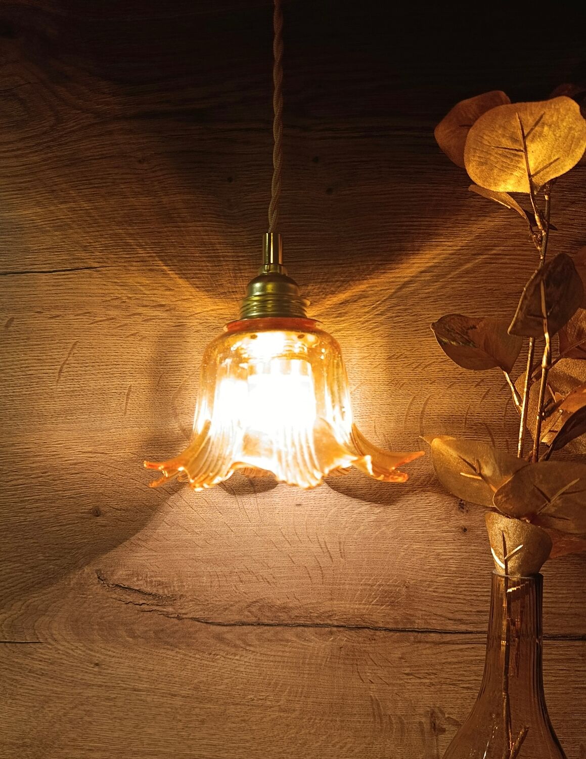 Amber tulip glass portable lamp, golden braided cord.