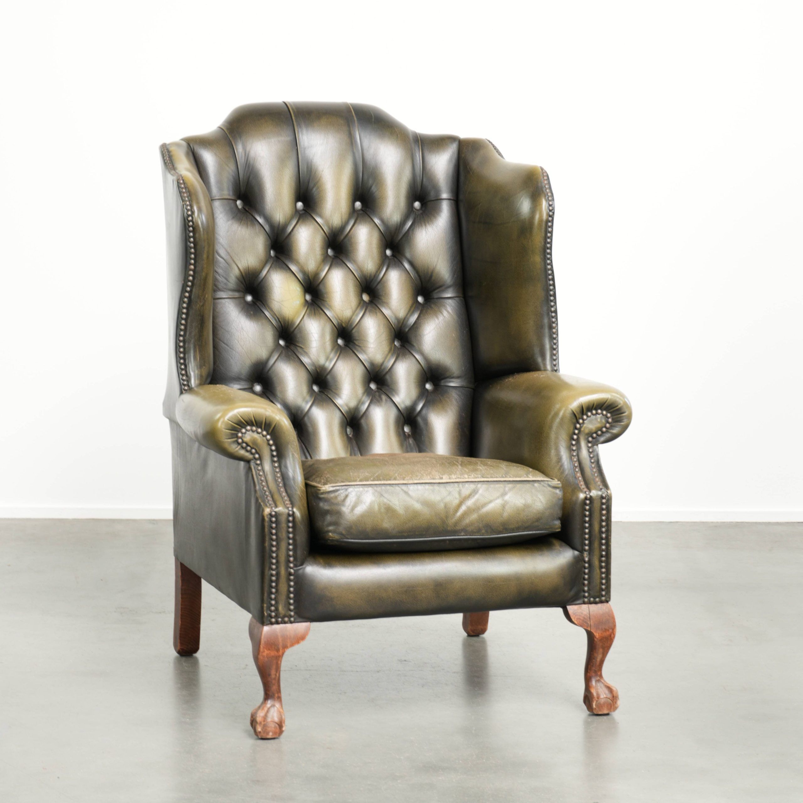 Vintage cowhide leather Chesterfield wingback armchair in a green colour