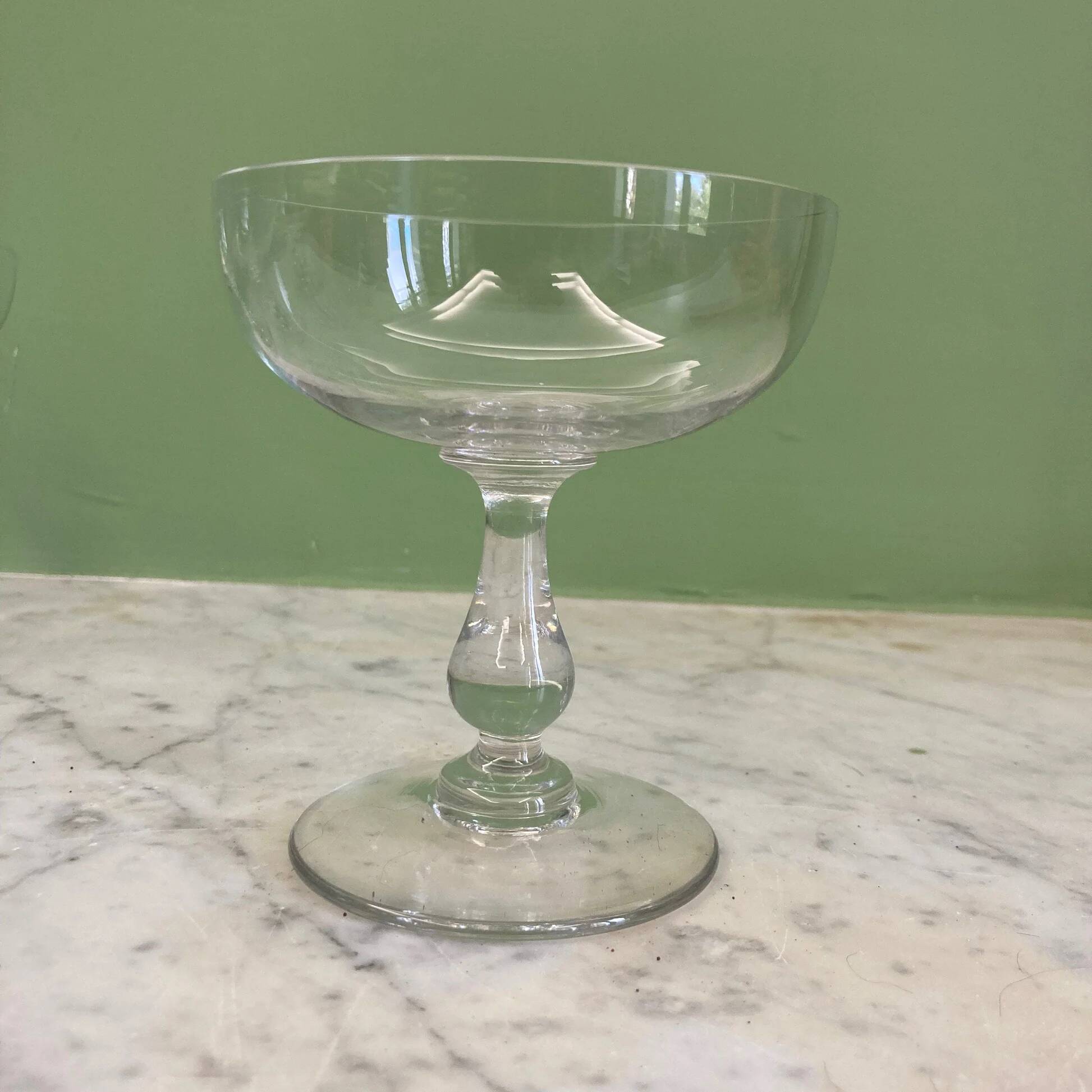 4 Baccarat crystal champagne coupes in a gondola shape.