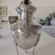 Empire-style silver-plated coffee pot with eagle head spout.