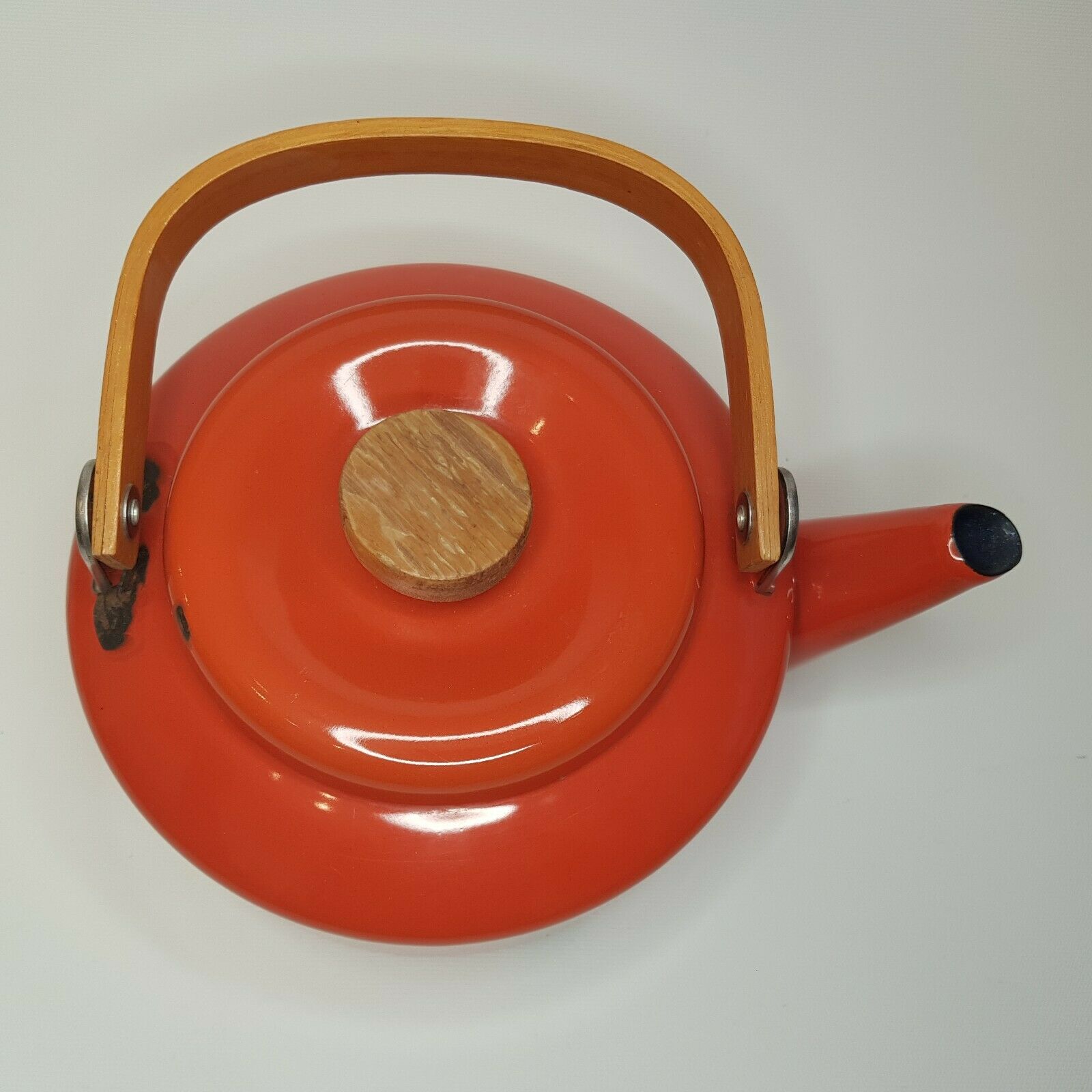 Orange and bamboo enamelled metal teapot in the 1970s