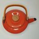 Orange and bamboo enamelled metal teapot in the 1970s