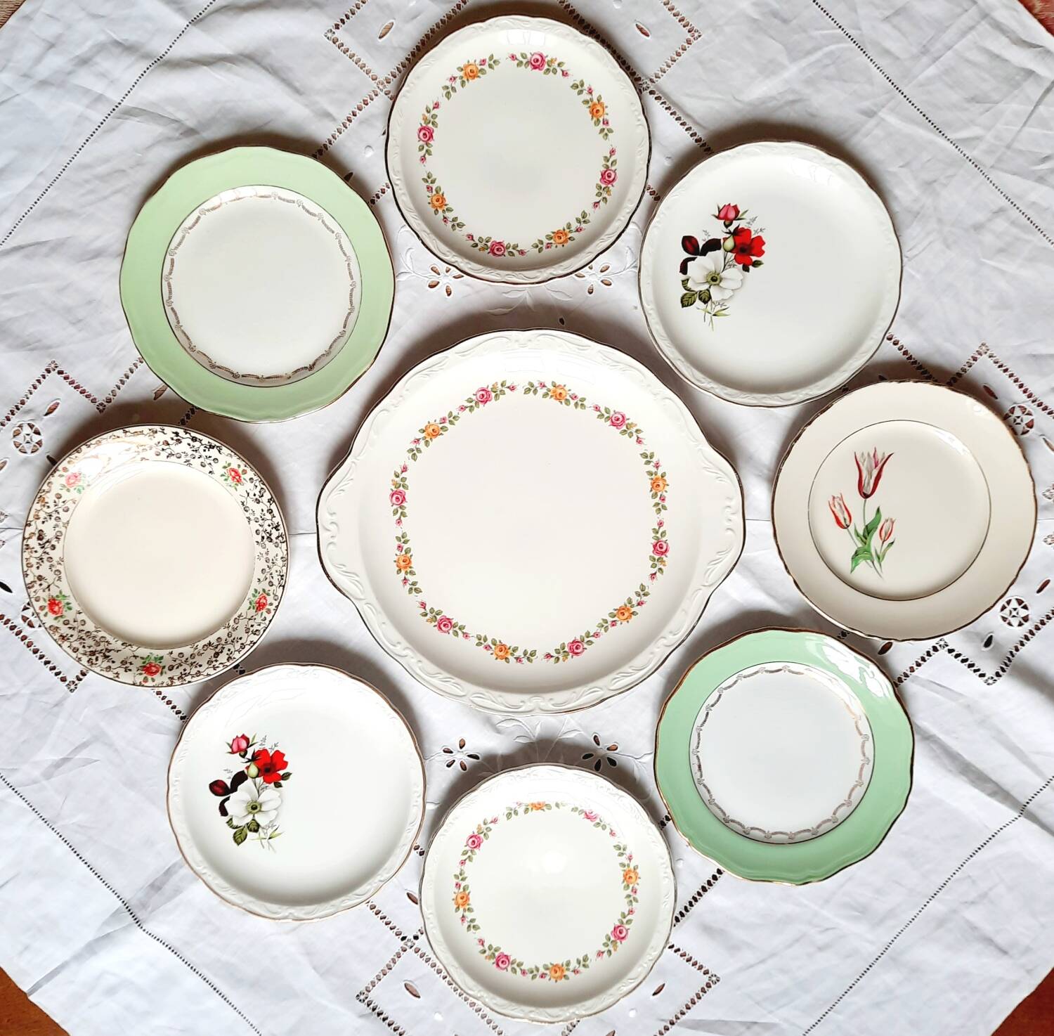 Old mismatched earthenware dessert plates with gold accompanied by a dish