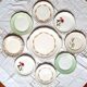 Old mismatched earthenware dessert plates with gold accompanied by a dish