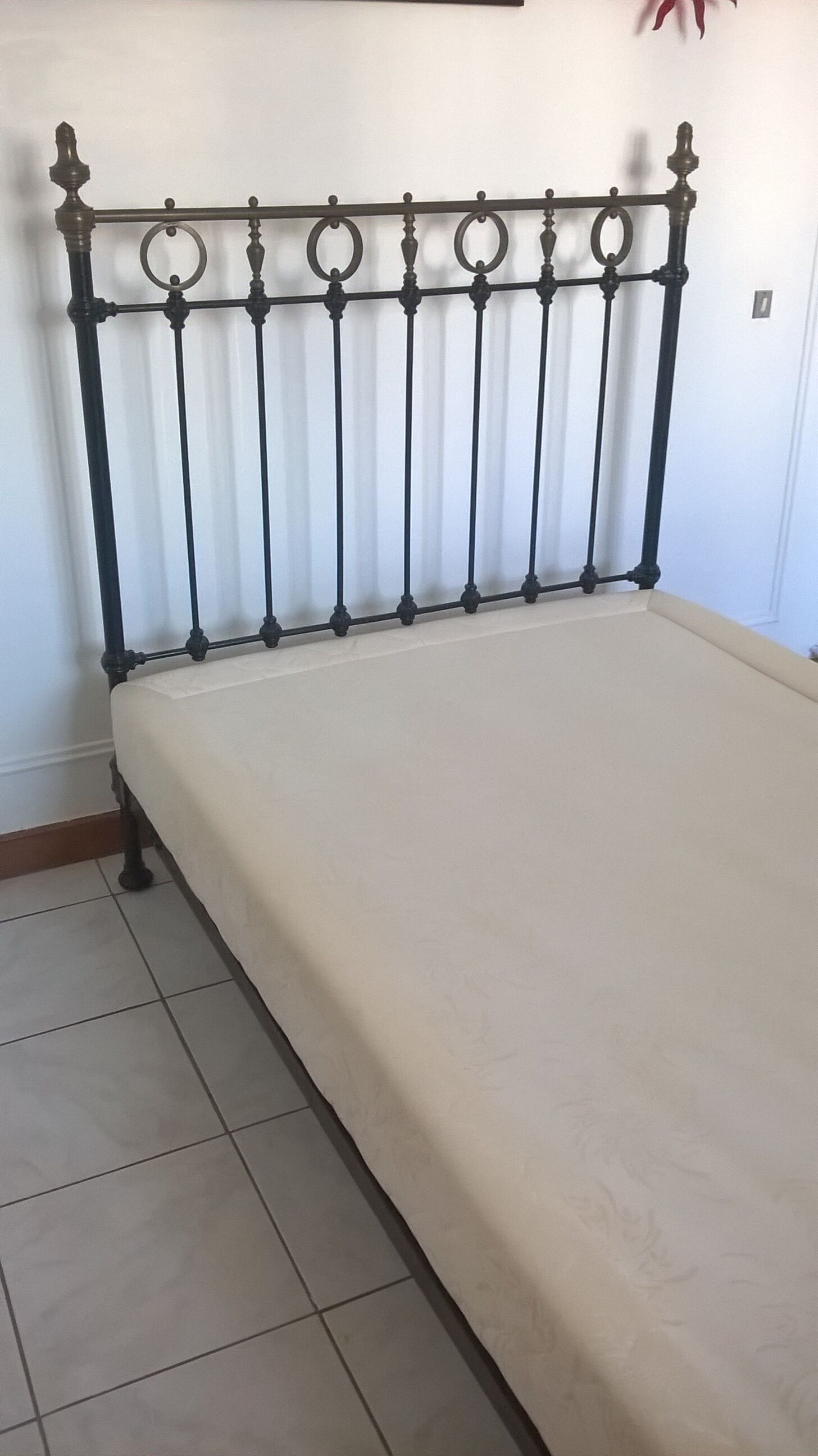 Old bed in black iron and brass